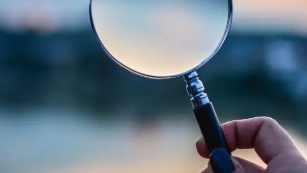 holding magnifying glass
