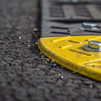 Grey and yellow speed bump close up
