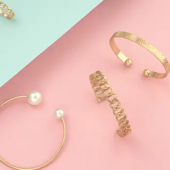 bracelets and rings on pink and blue background