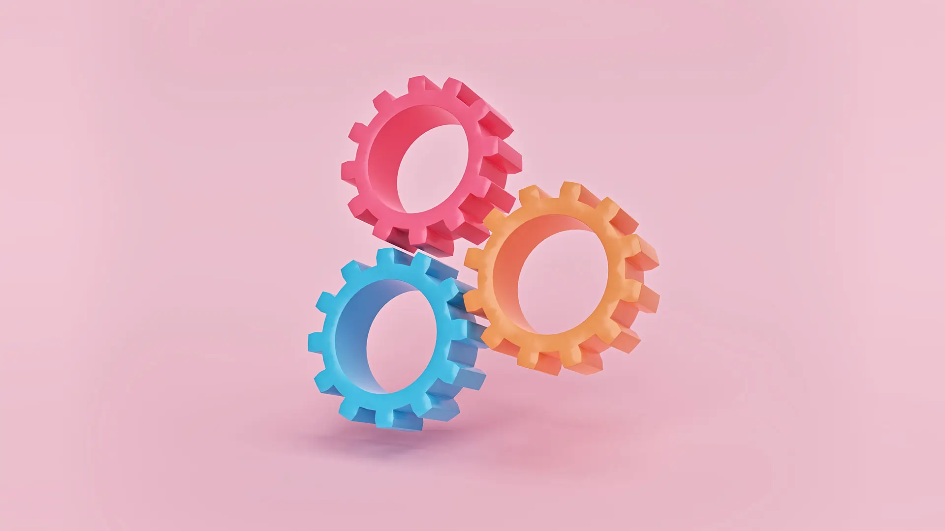 3d render of three gears on pink background