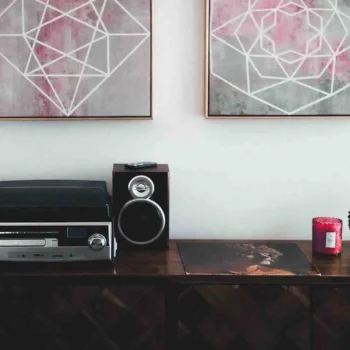 Black shelf stereo on a brown wooden sideboard