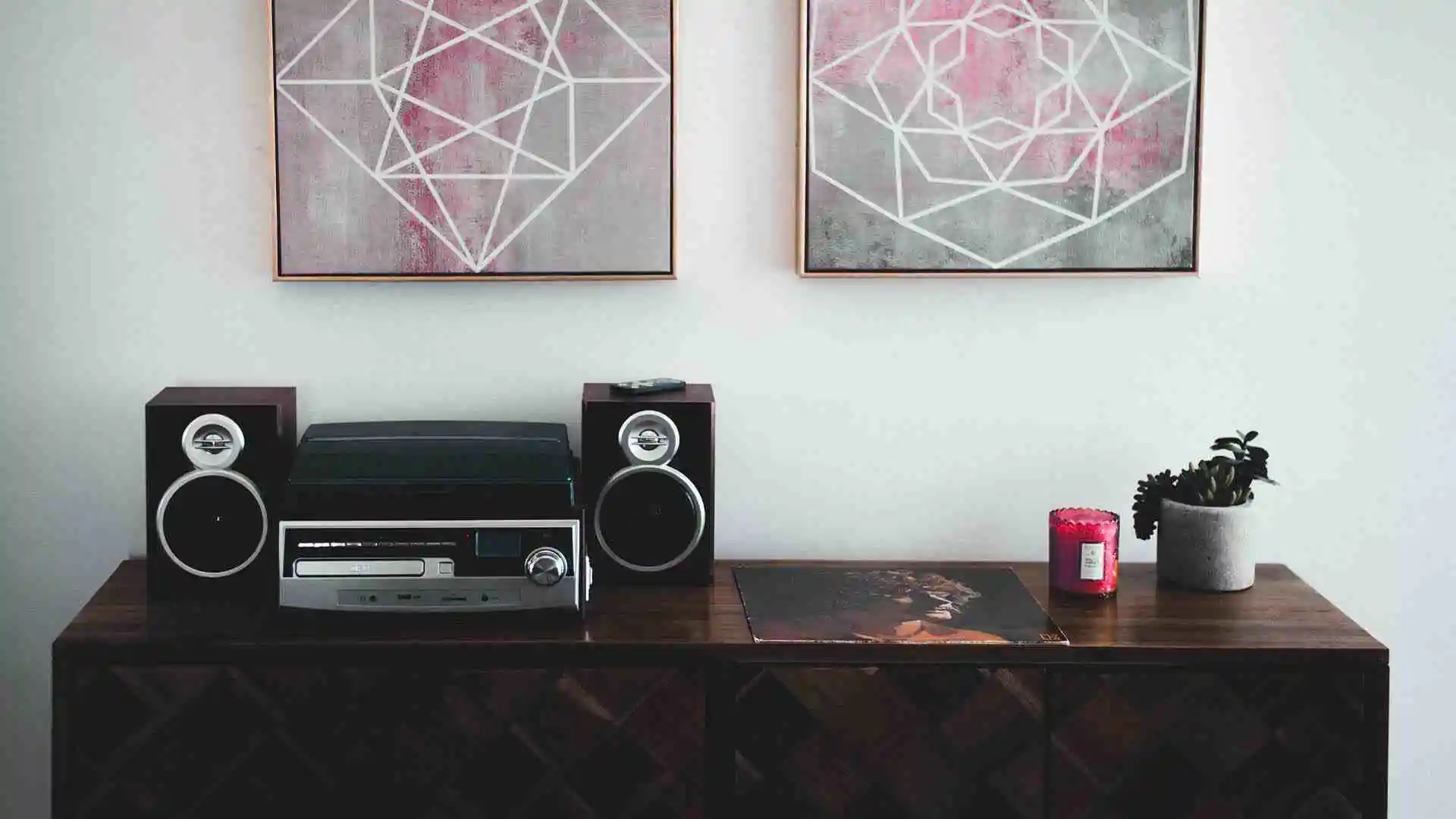 Black shelf stereo on a brown wooden sideboard