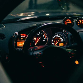 Orange lights on car speedometer and dashboard at night