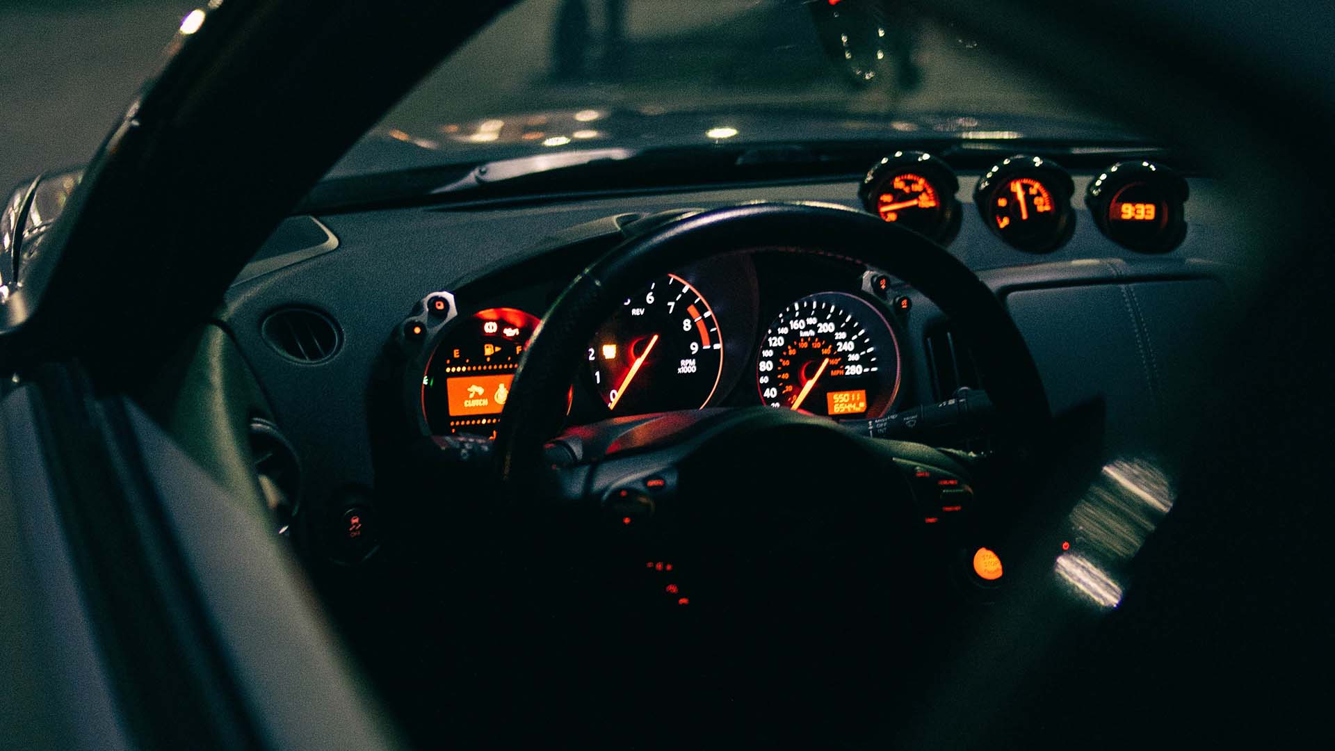 Orange lights on car speedometer and dashboard at night