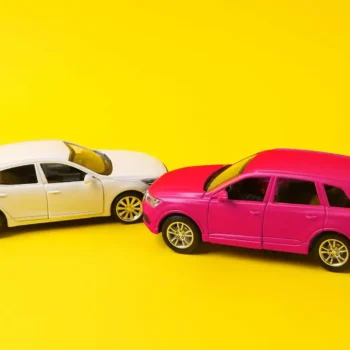 two toy cars posed in a fender bender