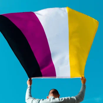 Person waving a non-binary Pride flag