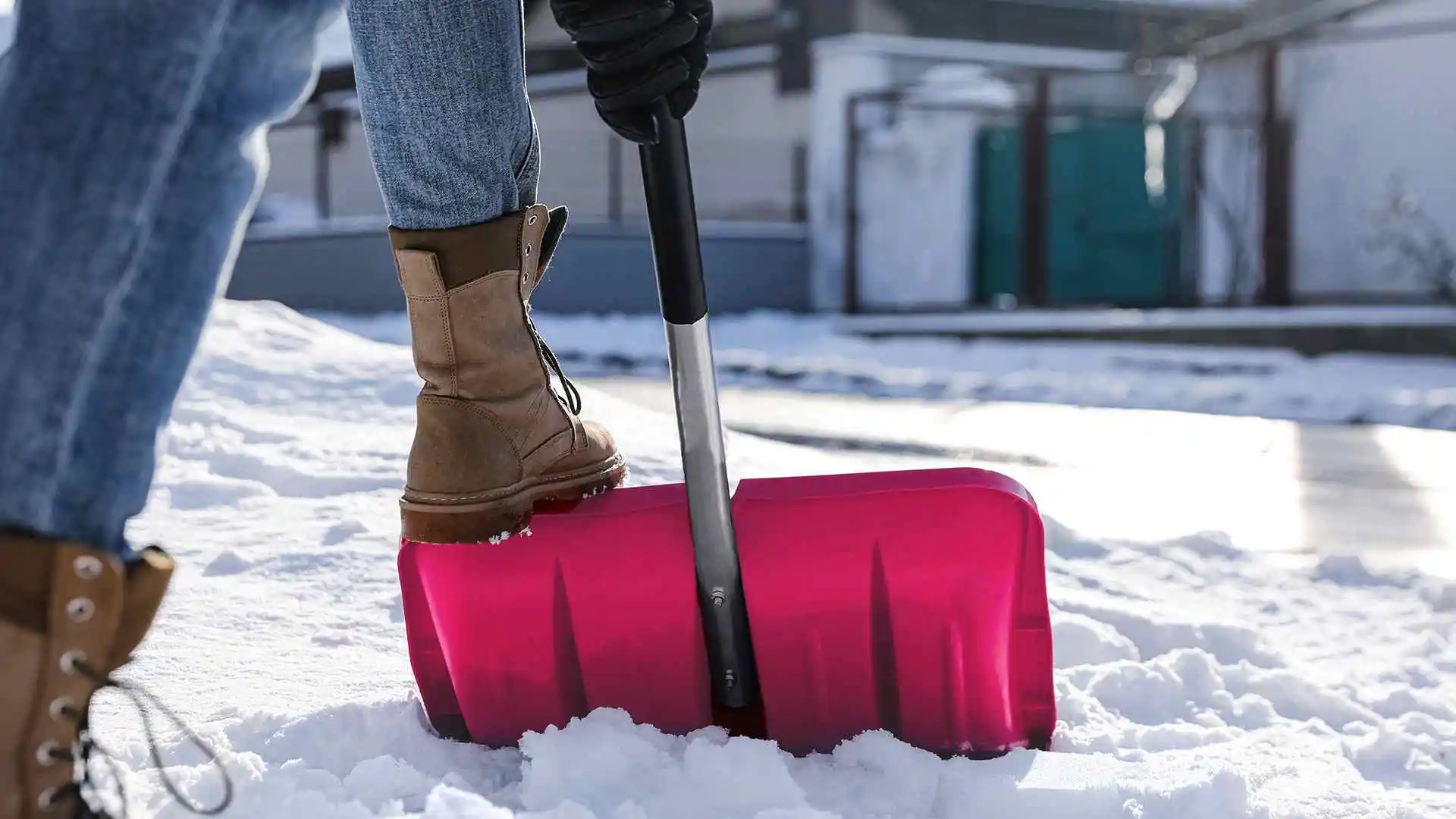 person shoveling snow on sidewalk