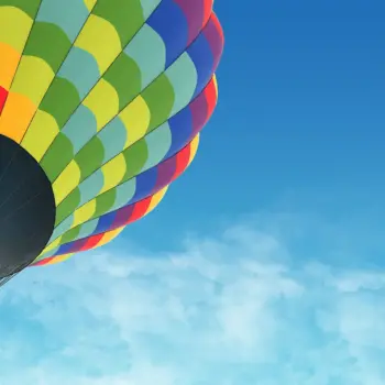 hot air balloon in the blue sky with clouds