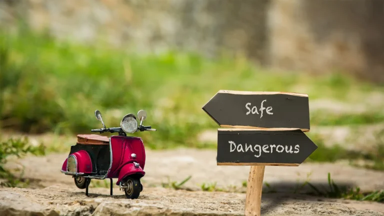 toy moped with sign indicating safety and danger