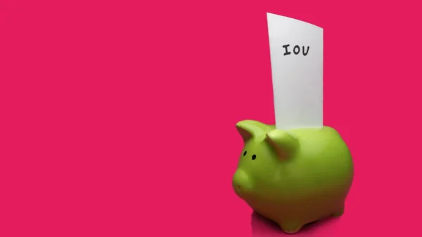 piggy bank with IOU instead of payment