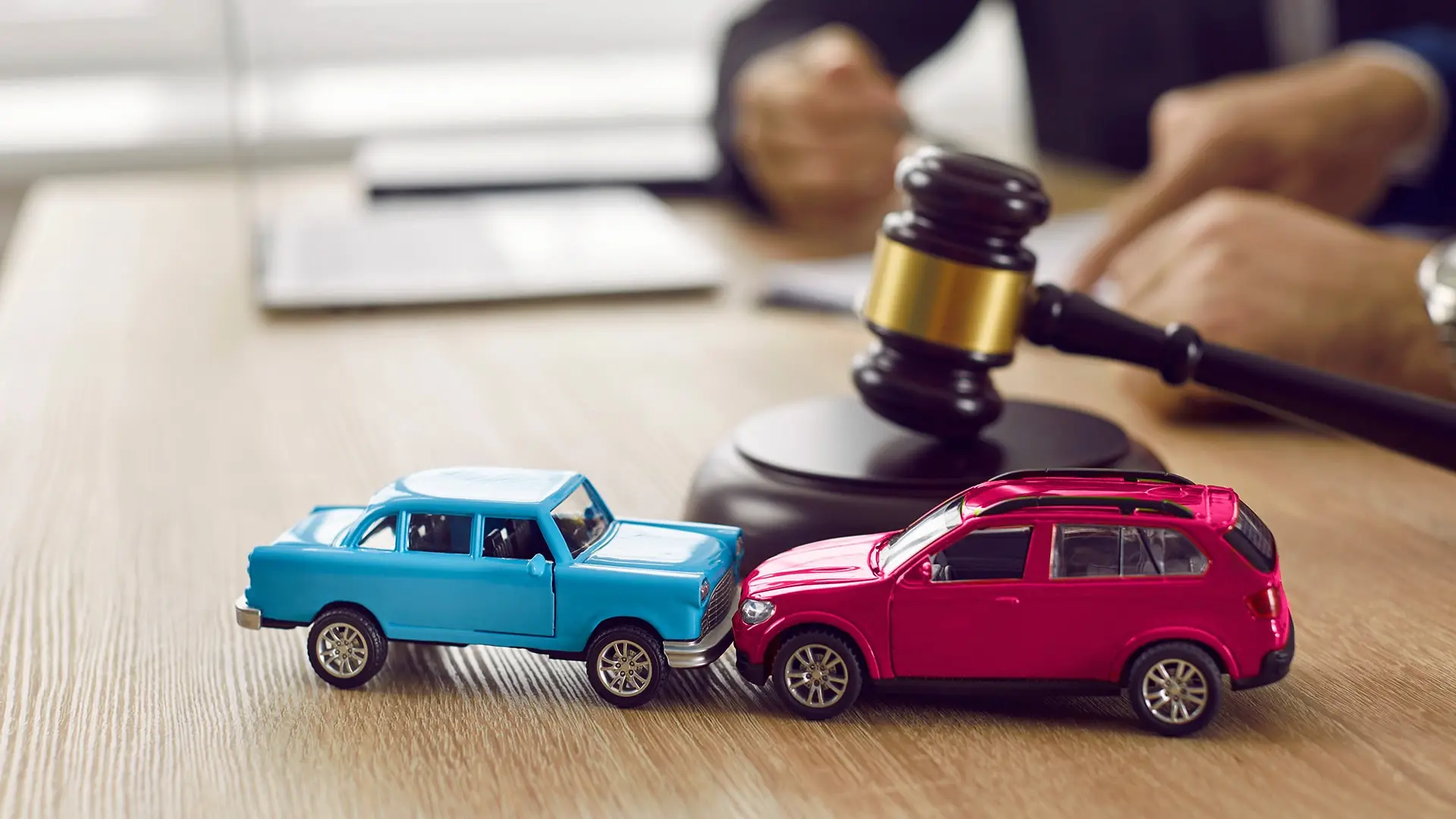 toy cars in pretend accident with judge gavel