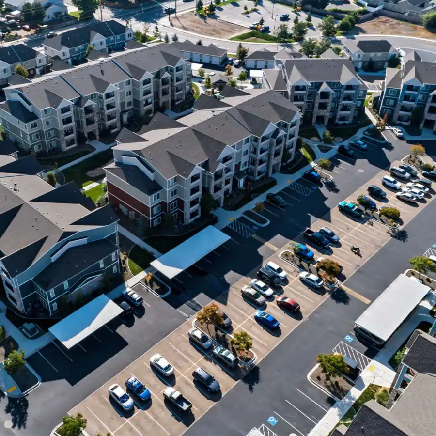 Condo complex with cars.