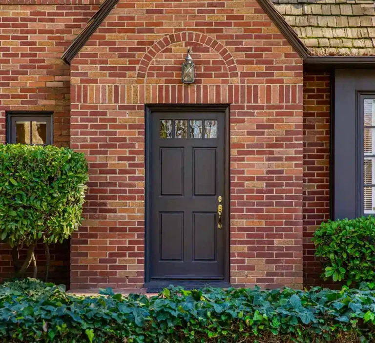 front view of brick house with black front door