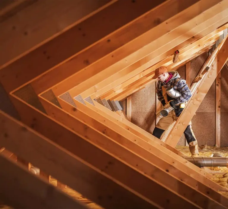 contractor working in rafters of construction build