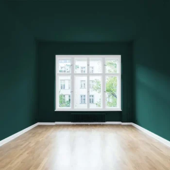 freshly painted room with wood flooring and bright window
