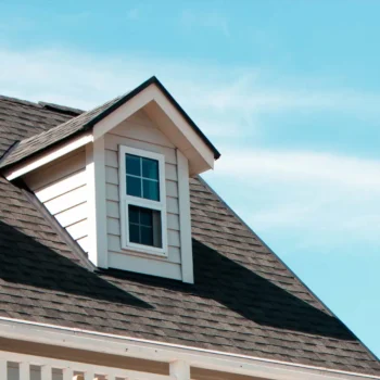 roof with attic window and sky background