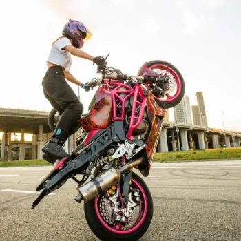 female rider doing stunt on motorcycle