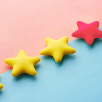 gold and raspberry puffy stars on pink and blue background