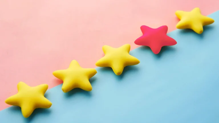 gold and raspberry puffy stars on pink and blue background