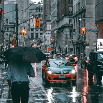 person walking on the street in the rain in city