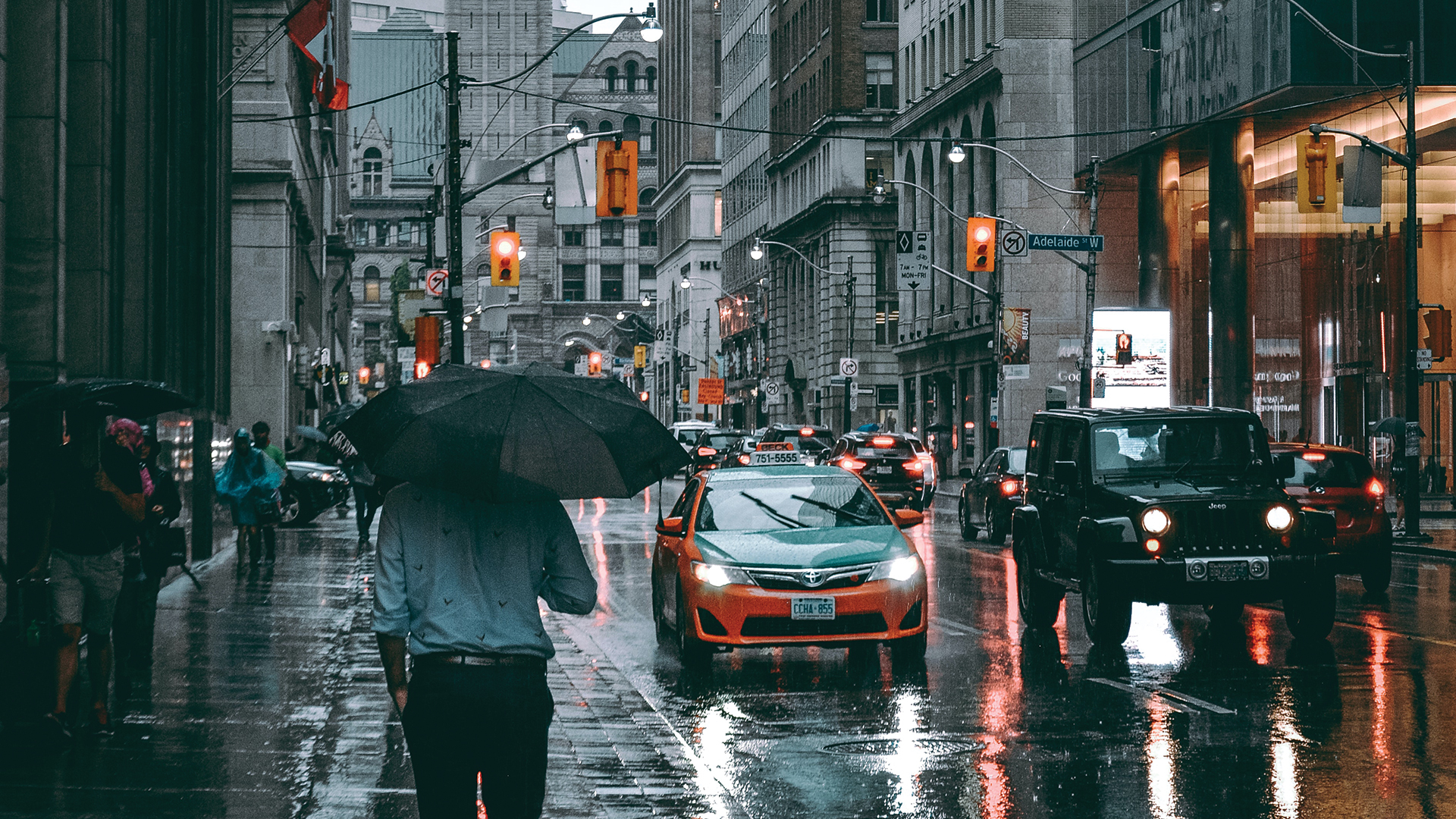 person walking on the street in the rain in city