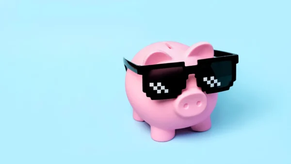 pink ceramic piggy bank wearing pixel shades