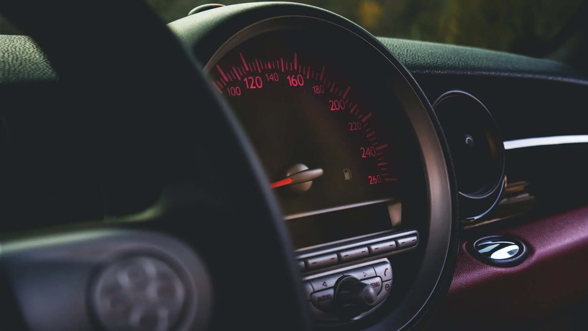 Large speedometer on black dashboard