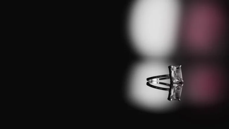 diamond ring on black surface with reflection
