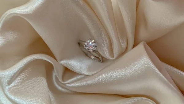 engagement ring nestled in satin fabric