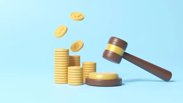 Stack of coins and judge gavel on blue background