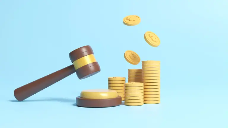 Stack of coins and judge gavel on blue background.