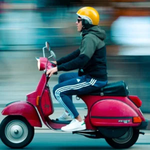 rider on moped with yellow helmet
