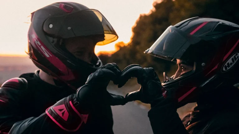 two riders making a heart with their hands