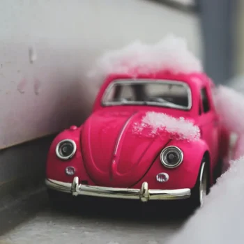 pink toy car in snow