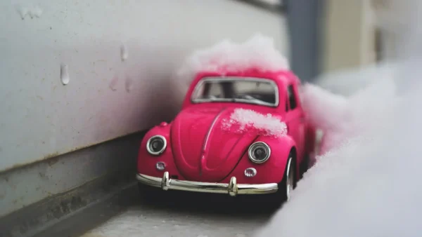 pink toy car in snow