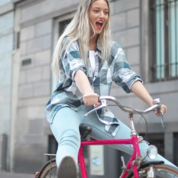 woman riding pink bicycle smiling
