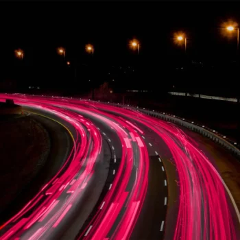 expressway at night with pink tail lights