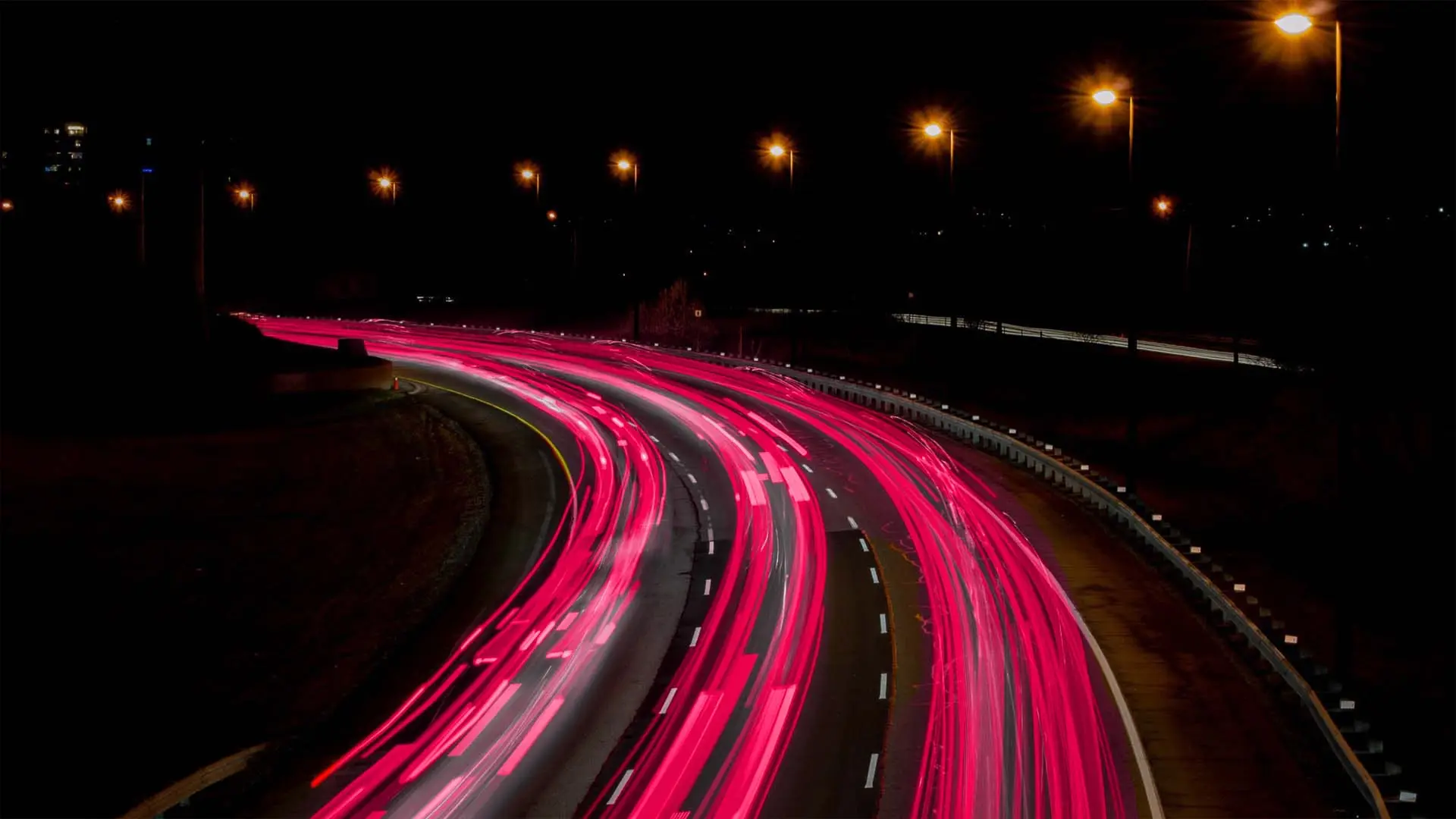expressway at night with pink tail lights