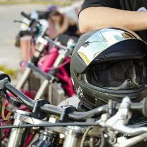 biker arm leaning on motorcycle helmet