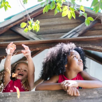 two girls laughing in tree house