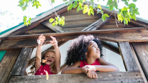 two girls laughing in tree house