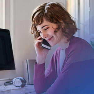 Smiling woman o phone in office setting