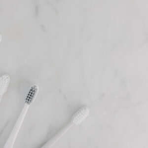 Toothbrushes on marble counter.