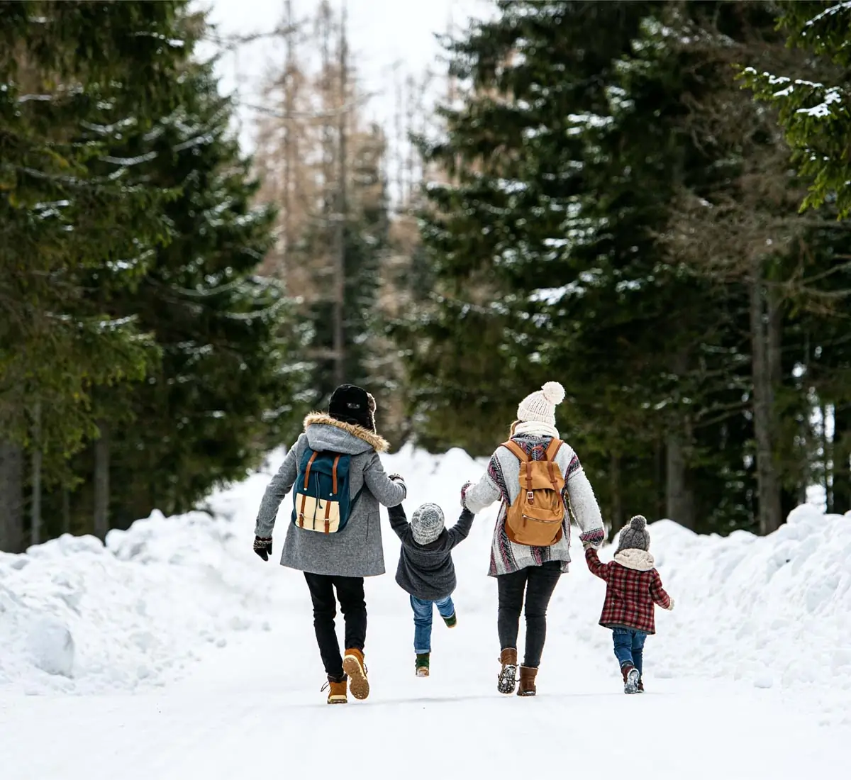 Family taking a winter walk on a forest trail.