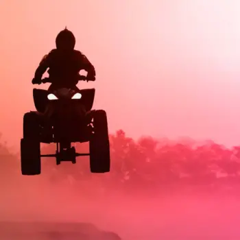 Quad bike jumping in the sunset.