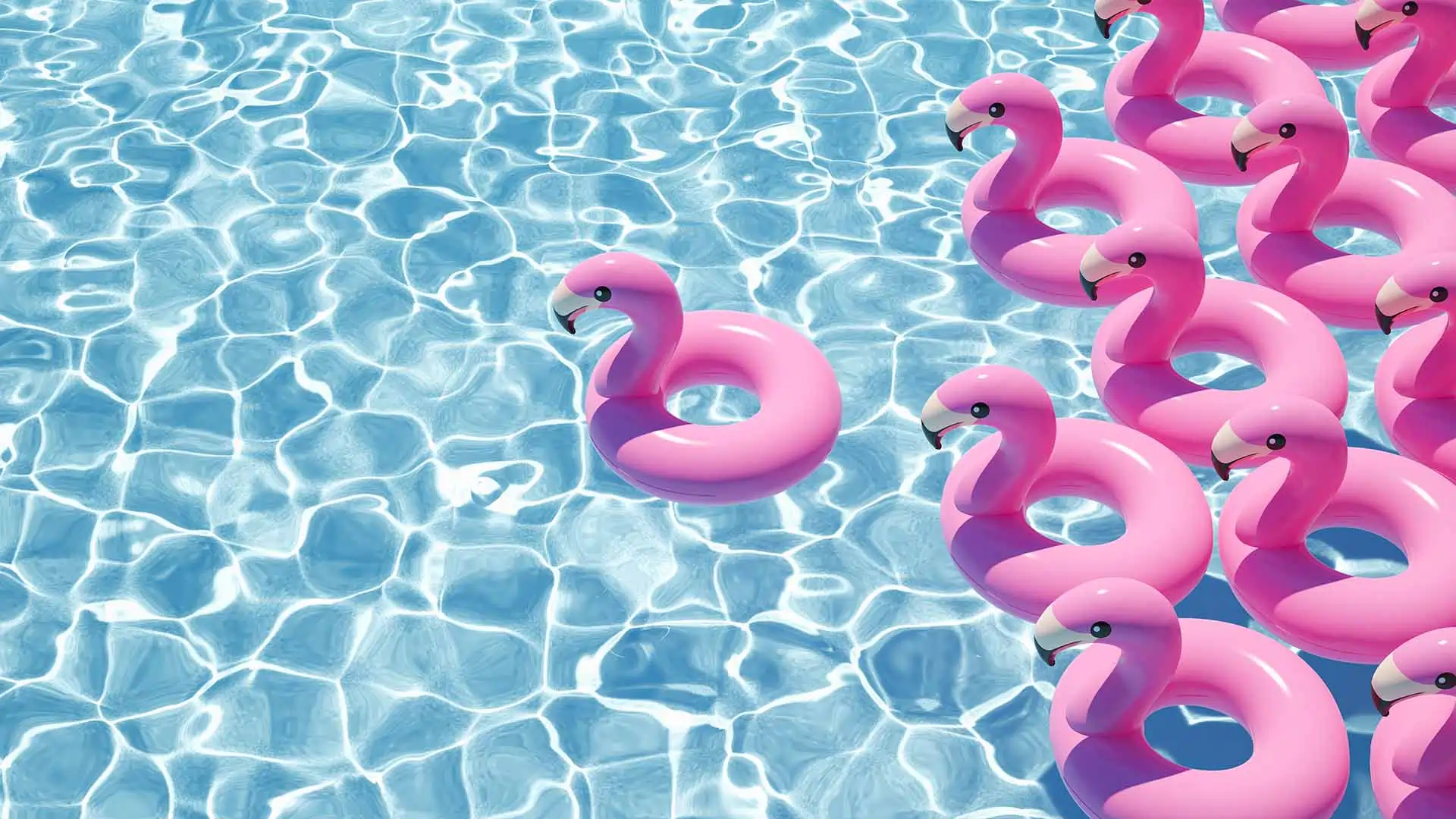 Flock of inflatable pool flamingos in the pool of a summer home.