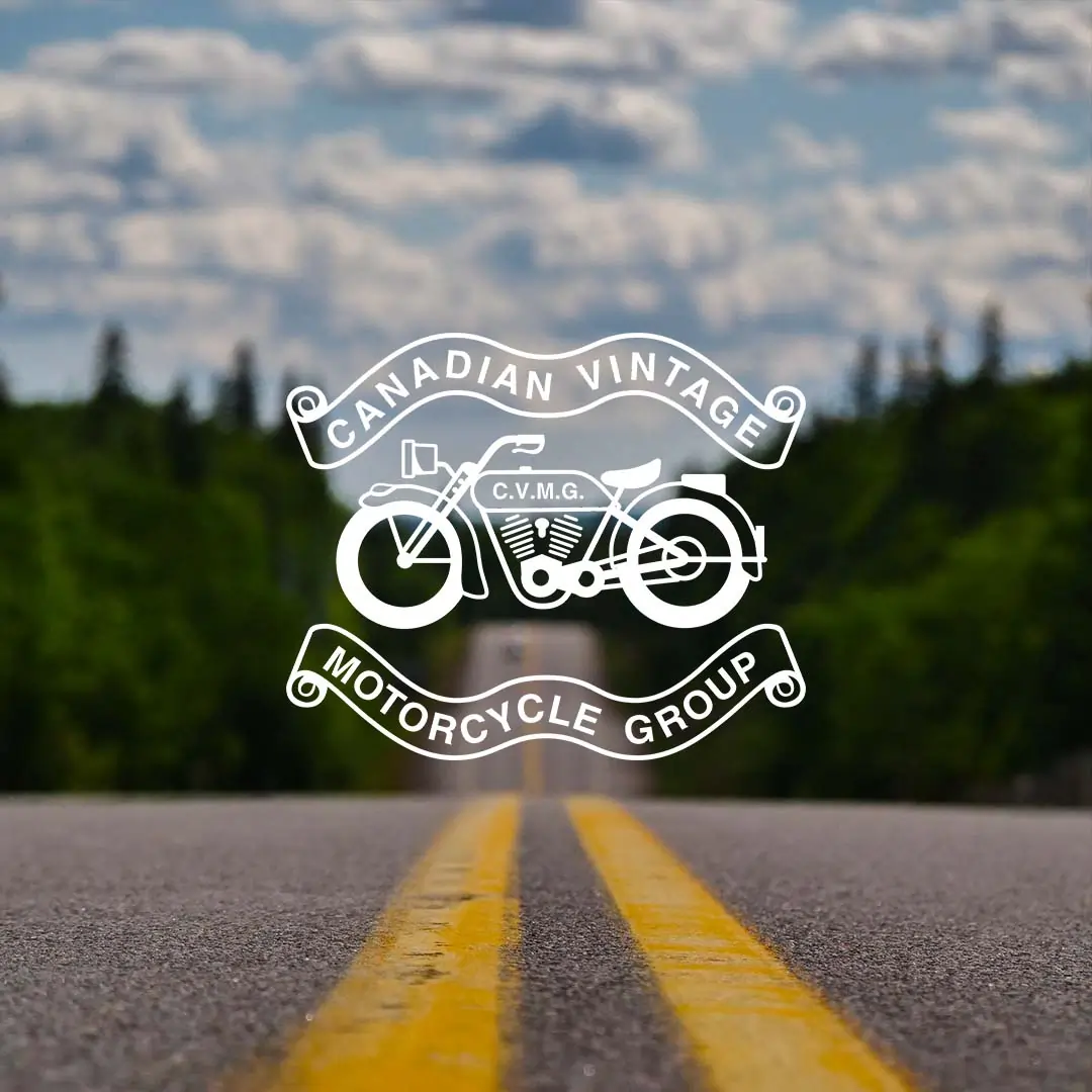CVMG logo on image of road with double yellow line between forested hills.