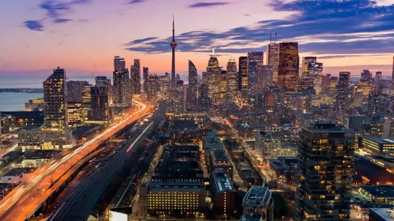 Cars driving in Toronto cityscape.