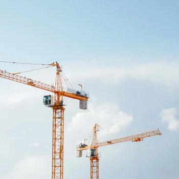 Building cranes at construction site.