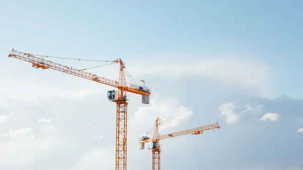 Building cranes at construction site.